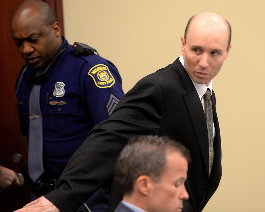 Defendant John Kelsey looks back at family and friends seated behind him in the courtroom Wednesday, May 28, 2015, after he entered the courtroom at the start of his trial in the death of Ingham County Deputy Grant Whitaker, who crashed while chasing an SUV. Prosecution and defense lawyers gave opening statements Thursday in the case against Kelsey of Stockbridge. He’s charged with fleeing or eluding police causing death and driving on a suspended license causing death. (Dave Wasinger/Lansing State Journal via AP)