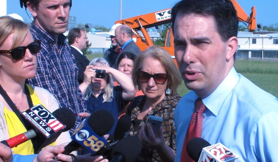 Gov. Scott Walker discusses ongoing state budget negotiations on Thursday, May 28, 2015, in Portage, Wis. Walker says he remains opposed to a vehicle registration fee increase or gas tax hike to help pay for state highway construction and repair in Wisconsin. (AP Photo/Scott Bauer)