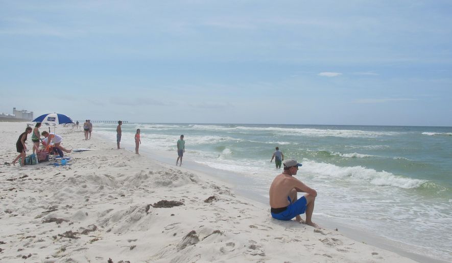 In this photo taken Wednesday, May 27, 2015, shows beach goers enjoying a morning at Pensacola Beach, Fla. While summer is the traditional down time for tourist resorts in hot and muggy South Florida, it is peak season 500 miles north in the beach towns of Florida’s Panhandle. From St. George Island in the east to Pensacola Beach in the west, there is plenty to explore in Florida’s often-forgotten Panhandle. (AP Photo/Melissa Nelson-Gabriel)
