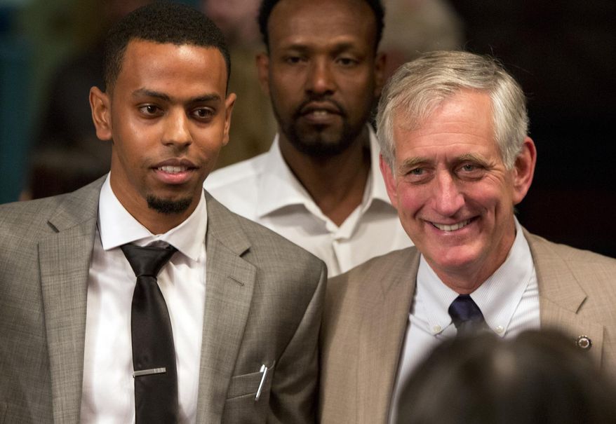 Khalid Ibrahim stands with Portland Mayor Charlie Hales after being sworn in Thursday, May 28, 2015, as Portland's first Somali-American police officer. (Dave Killen/The Oregonian via AP) MAGS OUT, TV OUT, NO LOCAL INTERNET (THE MERCURY, WILLAMETTE WEEK, PAMPLIN MEDIA GROUP OUT)