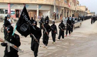 This undated file image posted on a militant website on Tuesday, Jan. 14, 2014, which has been verified and is consistent with other AP reporting, shows fighters from the al Qaeda-linked Islamic State of Iraq and the Levant (ISIL), now called the Islamic State group, marching in Raqqa, Syria.  **FILE**