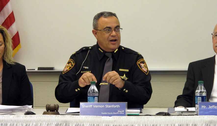 FILE - In this Thursday, Dec. 11, 2014 file photo, Fayette County Sheriff Vernon Stanforth addresses the Ohio Peace Officer Training Commission at the beginning of a special meeting in London, Ohio. Ohio’s statewide police commission is exploring the feasibility of a dramatic increase in the amount of advanced training law enforcement officers receive. The commission directed state police training academy officials on Thursday, May 28, 2015 to look at 40 hours of training for officers, including eight on use of force and eight on community policing. (AP Photo/Andrew Welsh-Huggins, File)