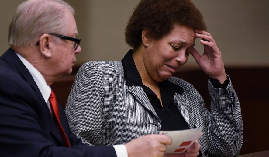 FILE - In this Feb. 5, 2015, file photo, Tewana Sullivan, right, alongside her attorney, John McWilliams, reacts while looking at photographs of herself when she was arrested, during a court hearing in Livonia, Mich. Sullivan, accused of killing a friend with a slow cooker during a political dispute while very drunk, pleaded guilty Thursday, May 28, 2015, to second-degree murder in a deal with prosecutors. (AP Photo/The Detroit News, Robin Buckson, File) DETROIT FREE PRESS OUT; HUFFINGTON POST OUT