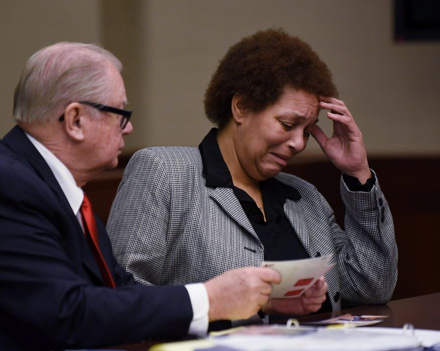 FILE - In this Feb. 5, 2015, file photo, Tewana Sullivan, right, alongside her attorney, John McWilliams, reacts while looking at photographs of herself when she was arrested, during a court hearing in Livonia, Mich. Sullivan, accused of killing a friend with a slow cooker during a political dispute while very drunk, pleaded guilty Thursday, May 28, 2015, to second-degree murder in a deal with prosecutors. (AP Photo/The Detroit News, Robin Buckson, File) DETROIT FREE PRESS OUT; HUFFINGTON POST OUT