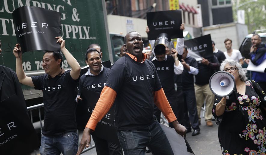 Uber drivers and their supporters protest in front of the offices of the Taxi and Limousine Commission in New York, Thursday, May 28, 2015. Uber and Lyft are pushing back against a New York City effort to regulate app-based car services. The proposal before the Taxi and Limousine Commission would require car services that riders can summon with their phones to comply with many of the rules that govern the yellow cabs they compete with. (AP Photo/Seth Wenig)