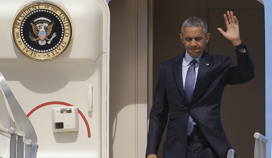 President Barack Obama waves as he disembarks from Air Force One at Miami International Airport, Wednesday, May 27, 2015, in Miami. The president is attending two Democratic National Committee fundraisers and the National Hurricane Center in this overnight visit. (AP Photo/Lynne Sladky)