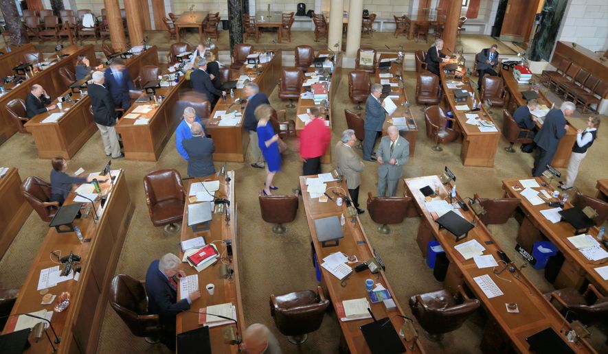 Nebraska lawmakers interact in the Legislative Chamber in Lincoln, Neb., Friday, May 29, 2015, on the last day of a legislative session that included a gas tax increase, the repeal of a ban on driver&#x27;s licenses for young immigrants and the abolition of the death penalty. (AP Photo/Nati Harnik)