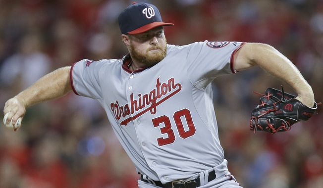 Washington Nationals relief pitcher Aaron Barrett throws in the sixth inning of a baseball game against the Cincinnati Reds, Friday, May 29, 2015, in Cincinnati. (AP Photo/John Minchillo) ** FILE **