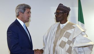 U.S. Secretary of State John Kerry, left, talks with newly inaugurated Nigerian President Muhammadu Buhari, before the start of a formal meeting in Abuja, Nigeria, Friday, May 29, 2015.  Nigerians celebrated their newly reinforced democracy Friday, dancing and singing at the inauguration of President Muhammadu Buhari, the first candidate to beat a sitting president at the polls. (AP Photo/Susan Walsh, Pool)
