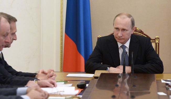 Russian President Vladimir Putin chairs a meeting of the Security Council in the Kremlin in Moscow, Russia, Friday, May 29, 2015.  Russian President Vladimir Putin signed a decree on Thursday to make losses of Russian troops who are on &quot;special operations&quot; in peacetime,  a state secret. (Alexei Nikolsky/RIA-Novosti, Kremlin Pool Photo via AP)
