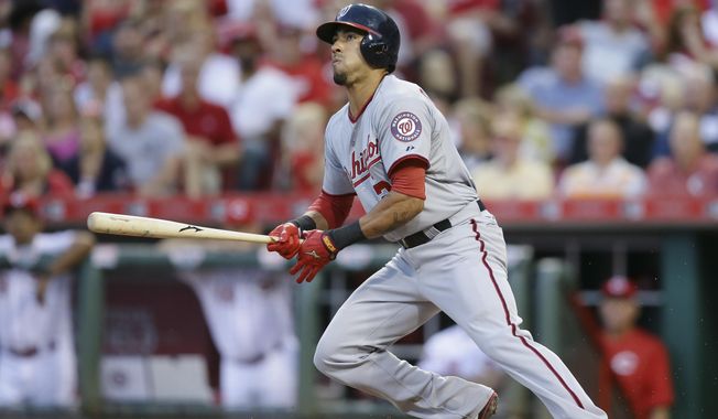Washington Nationals&#x27; Ian Desmond hits a single off Cincinnati Reds starting pitcher Anthony DeSclafani to drive home Michael Taylor in the fifth inning of a baseball game, Friday, May 29, 2015, in Cincinnati. (AP Photo/John Minchillo)