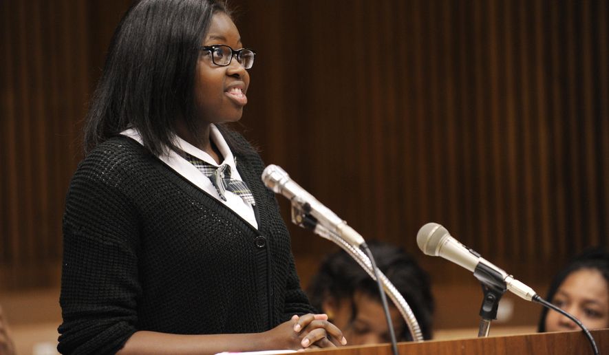 Lauren Phillips gives her opening remarks during a mock trial before Michigan Court of Appeals Judge Michael J. Riordan in Detroit on Thursday, May 28, 2015. Junior high students from the Detroit area have taken on bullying in the mock trial. Students from Cornerstone Charter Schools' Washington-Parks Academy in Redford Township made their case Thursday in Detroit. They have been preparing for the mock trial since last fall, with help from law students from the Western Michigan University Cooley Law School. (Clarence Tabb Jr./Detroit News via AP)