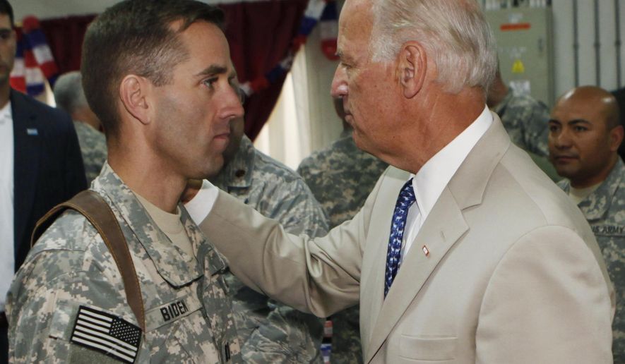 FILE - In this Saturday, July 4, 2009. file photo, U.S. Vice President Joe Biden, right, talks with his son, U.S. Army Capt. Beau Biden, at Camp Victory on the outskirts of Baghdad, Iraq. On Saturday, May 30, 2015, Vice President Biden announced the death of son, Beau, from brain cancer. (AP Photo/Khalid Mohammed, Pool)