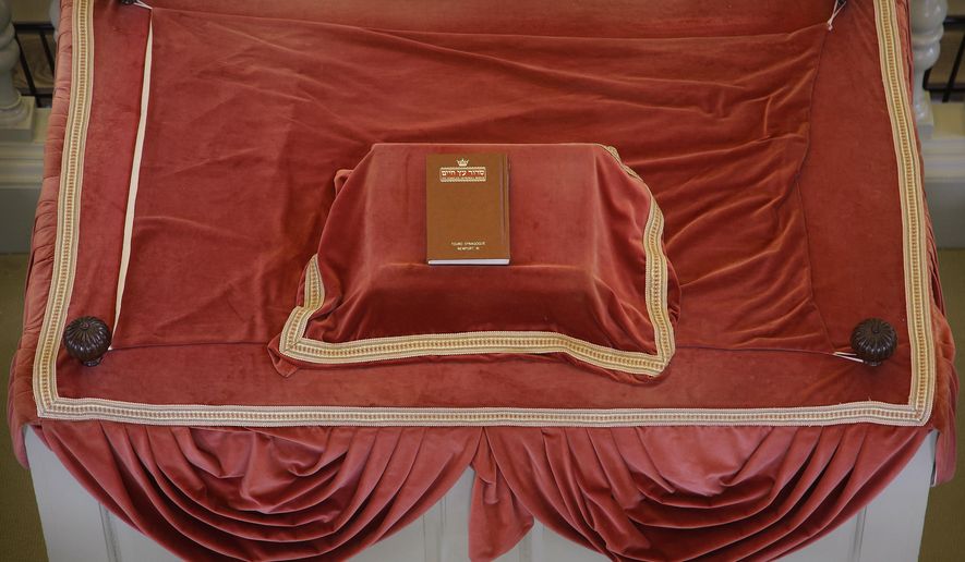 In this Thursday, May 28, 2015 photo, a siddur (prayer book), sits atop the "Bima" (reader's deck) at the Touro Synagogue, the nation's oldest at 250 years old, in Newport, Rhode Island. (AP Photo/Stephan Savoia)