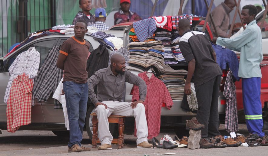 Many Zimbabweans turn their cars into makeshift secondhand clothing stores to beat unemployment, but reliance on Western providers leaves African industries struggling with slowed development. (Associated Press)