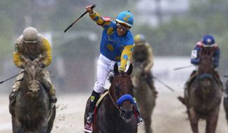 FILE - In this May 16, 2015, file photo, jockey Victor Espinoza, center, celebrates aboard American Pharoah after winning the 140th Preakness Stakes horse race at Pimlico Race Course in Baltimore. Last June, Espinoza was aboard California Chrome during his Triple Crown run that ended with a fourth-place finish in the Belmont. In 2002, he and trainer Bob Baffert teamed up with War Emblem to win the Kentucky Derby and Preakness before their Triple try ended when the colt stumbled out of the starting gate in the Belmont and finished eighth. Now, Espinoza and Baffert are back again with a colt many believed is poised to become the 12th Triple Crown winner and first since Affirmed in 1978. (AP Photo/Patrick Semansky, File)