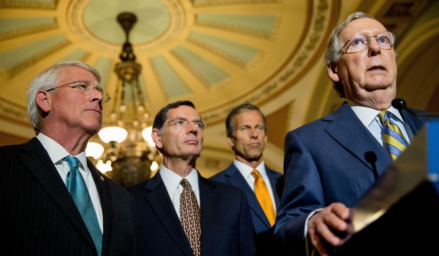 Senate Majority Leader Mitch McConnell of Ky., right, accompanied by, from left, Sen. Roger Wicker, R-Miss., Sen. John Barrasso, R-Wyo. and Sen. John Thune, R-S.D., speaks to the media during a news conference on Capitol Hill in Washington, Tuesday, June 2, 2015, following a Senate policy luncheon as legislation to end the National Security Agency's collection of Americans' calling records while preserving other surveillance authorities is expected to clear the Senate late Tuesday. But House leaders have warned their Senate counterparts not to proceed with planned changes to a House version. (AP Photo/Andrew Harnik)