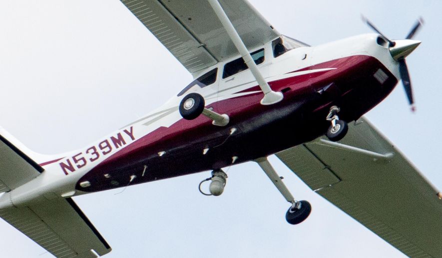 In this photo taken May 26, 2015, a small plane flies near Manassas Regional Airport in Manassas, Va. The plane is among a fleet of surveillance aircraft by the FBI, which are primarily used to target suspects under federal investigation. Such planes are capable of taking video of the ground, and some _ in rare occasions _ can sweep up certain identifying cellphone data. (AP Photo/Andrew Harnik)