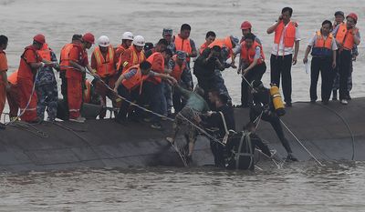 In this photo released by China&#x27;s Xinhua News Agency, rescuers save a survivor, center, from the overturned passenger ship in the Jianli section of the Yangtze River in central China&#x27;s Hubei Province Tuesday, June 2, 2015. Rescuers pulled several survivors to safety after hearing cries for help Tuesday from inside a capsized cruise ship that went down overnight in a storm on China&#x27;s Yangtze River, state broadcaster CCTV said. (Cheng Min/Xinhua via AP)