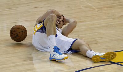 File-This May 27, 2015, file photo shows Golden State Warriors guard Klay Thompson on the court after being injured during the second half of Game 5 of the NBA basketball Western Conference finals against the Houston Rockets in Oakland, Calif. When NBA union chief Michele Roberts watched Stephen Curry return to a game after his head slammed against the floor and he walked woozily to the locker room, she immediately boned up on the league's concussion protocols.  Two nights later, when Curry's Golden State teammate Klay Thompson was cleared to return after being kneed in the head only to later be diagnosed with a concussion, her reaction was much stronger.  "It mortified me," she said.  (AP Photo/Tony Avelar, File)