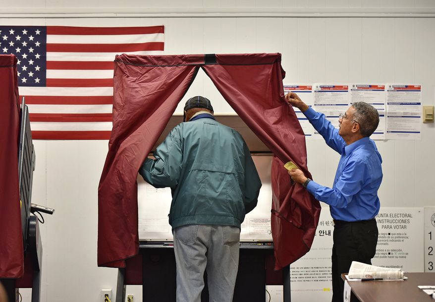 Englewood resident William Hurt, 83, enters a voting machine as board worker Fernando Rosario opens the curtain at the polls in the Democratic primary, Tuesday, June 2, 2015, at Liberty School in Englewood, N.J. (Mitsu Yasukawa/The Record of Bergen County via AP)