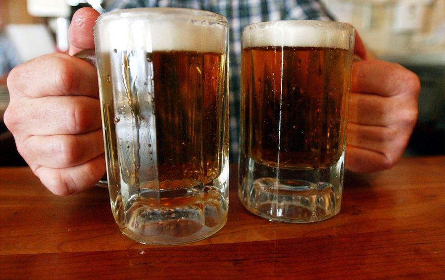 In this June 29, 2004, file photo, a bartender serves two mugs of beer at a tavern in Montpelier, Vt. Alcohol problems affect almost 33 million adults and most have never sought treatment. That's according to a government survey indicating that rates have increased in recent years. (AP Photo/Toby Talbot, File)
