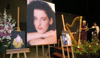 In this photo taken at the Modesto Centre Plaza in Modesto, Calif., on May 28, 2002, photos of Chandra Levy are on display as musicians stand by at her memorial service. Ingmar Guandique was convicted in 2010 of killing Levy, a Washington intern. (Associated Press) **FILE**