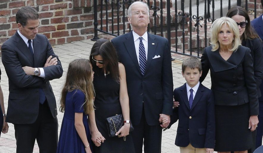 Vice President Joe Biden, center, pauses alongside his family as they to enter a visitation for his son, former Delaware Attorney General Beau Biden, Thursday, June 4, 2015, at Legislative Hall in Dover, Del. Standing with Biden are his son Hunter, from left, granddaughter Natalie, daughter-in-law Hallie, grandson Hunter and wife Jill. Beau Biden died of brain cancer Saturday at age 46. (AP Photo/Patrick Semansky, Pool)