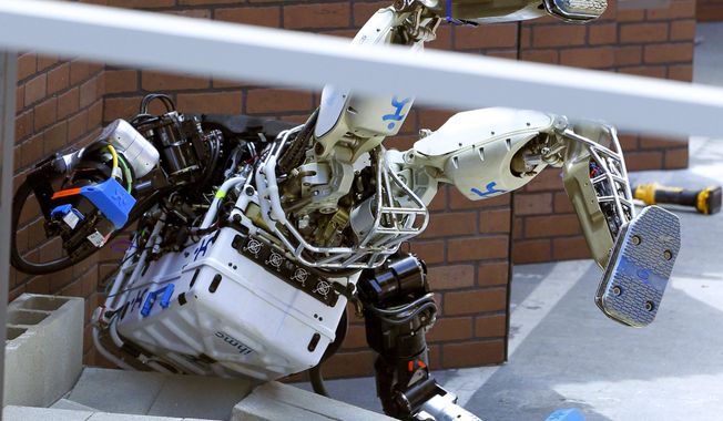 Robot Running Man from the Florida Institute for Human and Machine Cognition takes a tumble during the competition in the U.S. Defense Advanced Research Projects Agency Robotics Challenge in Pomona, Calif., Friday, June 5, 2015. (AP Photo/Alex Gallardo) ** FILE **