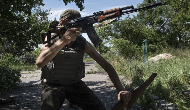 A Ukrainian serviceman patrols the area near the division line with separatists in Marinka, near Donetsk, eastern Ukraine, Friday, June 5, 2015. As fears persist that eastern Ukraine is about to fall back into full-scale war, a leader of the international monitoring group is urgently calling for resumed negotiations. (AP Photo/Evgeniy Maloletka)