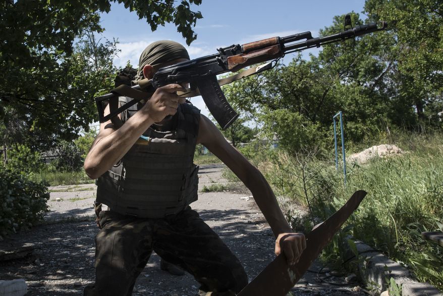 A Ukrainian serviceman patrols the area near the division line with separatists in Marinka, near Donetsk, eastern Ukraine, Friday, June 5, 2015. As fears persist that eastern Ukraine is about to fall back into full-scale war, a leader of the international monitoring group is urgently calling for resumed negotiations. (AP Photo/Evgeniy Maloletka)