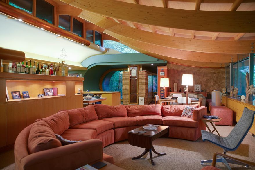 Curved laminated beams create a flowing ceiling in the the centerpiece room designed in 1997 by architect Robert Harvey Oshatz and built in 2004 on a steep lot in Portland's West Hills. For his client, a music lover, Oshatz orchestrated a modern, wood-and-glass house that has a curving, cedar ceiling and other acoustic-enhancing shapes and materials. More than amphitheater-quality sound, however, the Wilkinson residence, in a forested part of Southwest Portland, artfully blends two fields: Architecture and music. (Randy L. Rasmussen/The Oregonian via AP)