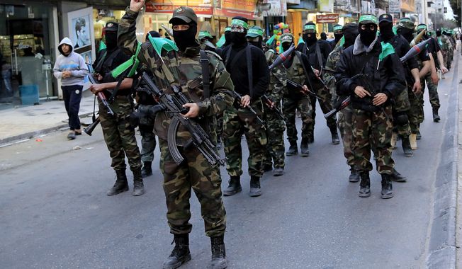 Palestinian masked militants of Izzedine al-Qassam Brigades, a military wing of Hamas, take part in a parade to mark the 11th anniversary of the Israeli assassination of Hamas spiritual leader Sheikh Ahmad Yassin in Gaza, in the northern Gaza Strip, March 23, 2015. (Associated Press) ** FILE **