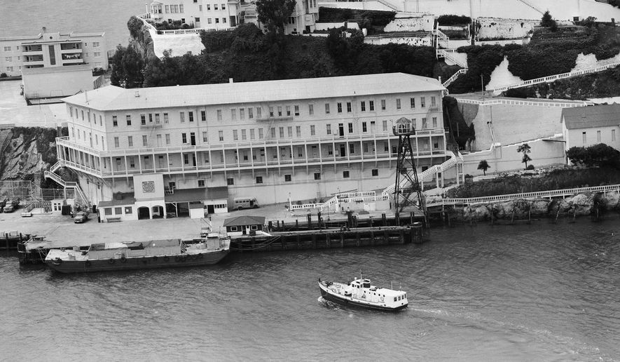 FILE - In this June 12, 1962, file photo, Alcatraz Federal Penitentiary in San Francisco Bay is shown the day three prisoners escaped. The men crawled through holes they'd cut in their cell walls, climbed to the roof and left on a raft fashioned from prison raincoats and rubber cement. They were never found; officials surmised they may have drowned before reaching shore. (AP Photo/File)