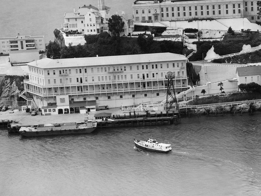 FILE - In this June 12, 1962, file photo, Alcatraz Federal Penitentiary in San Francisco Bay is shown the day three prisoners escaped. The men crawled through holes they'd cut in their cell walls, climbed to the roof and left on a raft fashioned from prison raincoats and rubber cement. They were never found; officials surmised they may have drowned before reaching shore. (AP Photo/File)