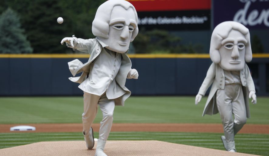 As part of an effort to promote tourism in the Black Hills of South Dakota, one of the U.S. Presidents depicted in the sculpture in the granite face of Mount Rushmore, George Washington, throws out the ceremonial first pitch under the watch of Thomas Jefferson before the Colorado Rockies host the Miami Marlins in a baseball game Sunday, June 7, 2015, in Denver. (AP Photo/David Zalubowski)