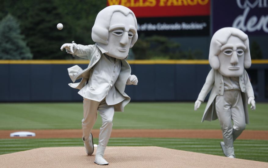 As part of an effort to promote tourism in the Black Hills of South Dakota, one of the U.S. Presidents depicted in the sculpture in the granite face of Mount Rushmore, George Washington, throws out the ceremonial first pitch under the watch of Thomas Jefferson before the Colorado Rockies host the Miami Marlins in a baseball game Sunday, June 7, 2015, in Denver. (AP Photo/David Zalubowski)