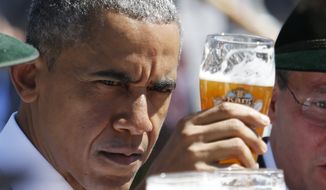 U.S. President Barack Obama toasts with a glass of beer during a visit to the village of Kruen, southern Germany, Sunday, June 7, 2015 prior to the G-7 summit in Schloss Elmau hotel near Garmisch-Partenkirchen starting later the day. (AP Photo/Markus Schreiber)