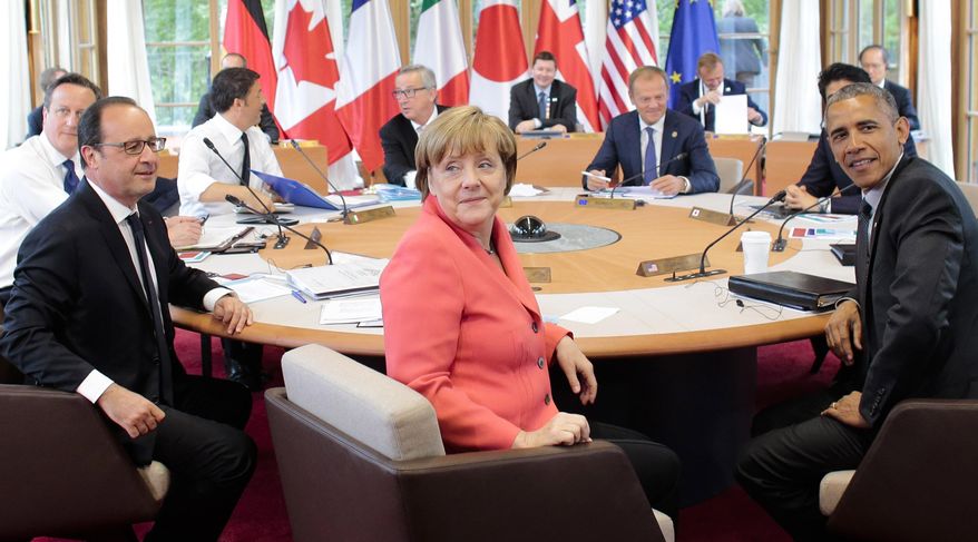 British Prime Minister David Cameron, French President Francois Hollande, Italian Prime Minister Matteo Renzi, EU Commission President Jean-Claude Juncker, German Chancellor Angela Merkel, European Council President Donald Tusk, Japanese Prime Minister Shinzo Abe, and U.S. President Barack Obama look to the media prior to the third working session at the G-7 summit in Schloss Elmau hotel near Garmisch-Partenkirchen, southern Germany, Monday, June 8, 2015. (AP Photo/Markus Schreiber)