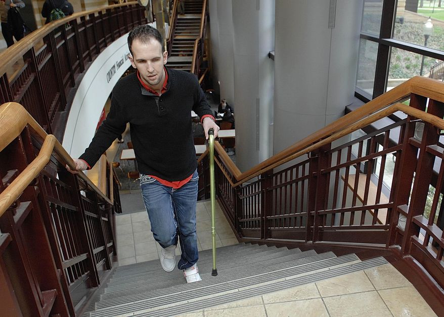 In this March 29, 2015 photo, Mike Trujillo, of Bollingbrook, Ill., walks up the steps at State Farm Hall at Illinois State University in Normal, Ill. He will graduate in 2015 with a degree in business from Illinois State University at the age of 25. A stroke seven years ago delayed his attending college, but he hopes his story will encourage others. (Lori Ann Cook-Neisler, The Pantagraph via AP)