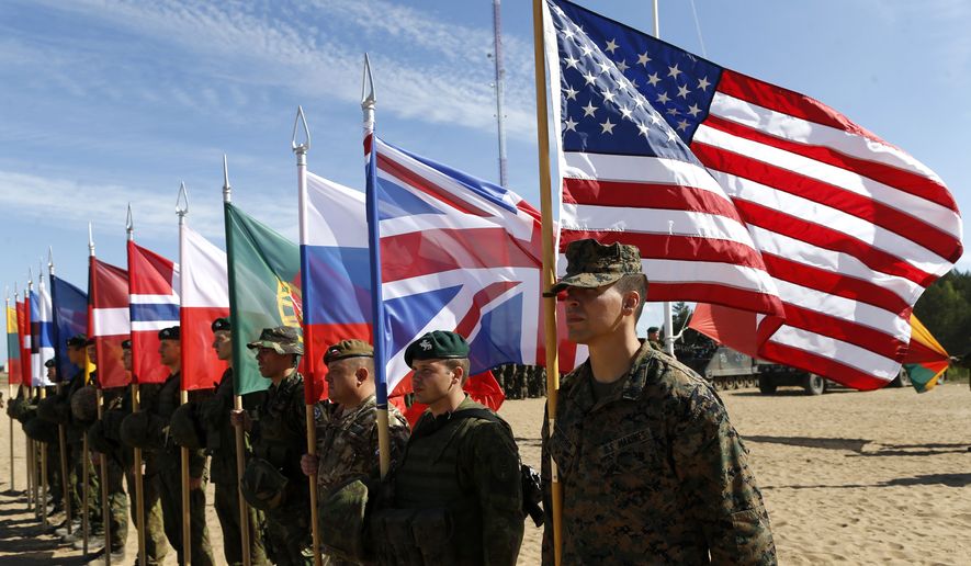 Soldiers from NATO countries attend a opening ceremony of military exercise &#39;Saber Strike 2015&#39;, at the Gaiziunu Training Range in Pabrade some 60km.(38 miles) north of the capital Vilnius, Lithuania, Monday, June 8, 2015. The annual multinational Exercise Saber Strike 2015 organized by the U. S. Army in Europe (USAREUR) on June 1 through 19 comprises brigade-level command post exercises held concurrently in all the three Baltic States and Poland. This year the exercise will train the record number of 6,000 troops from 13 NATO member and partner states - Denmark, Estonia, U.S.A., UK, Canada, Latvia, Poland, Lithuania, Norway, Germany, Portugal, Slovenia and Finland. (AP Photo/Mindaugas Kulbis)