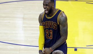 Cleveland Cavaliers forward LeBron James (23) celebrates after end of the overtime period of Game 2 of basketball&#39;s NBA Finals against the Golden State Warriors in Oakland, Calif., Sunday, June 7, 2015. The Cavaliers won 95-93 in overtime. (AP Photo/Eric Risberg)
