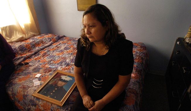 This Nov. 19, 2004, file photo shows Rosa Maria Peralta sitting on her son&#x27;s bed in his bedroom ash she reflects back on her memories with her son, Marine Sgt. Rafael Peralta, in San Diego, Calif.   (Nelvin Cepeda/U-T San Diego via AP, File)