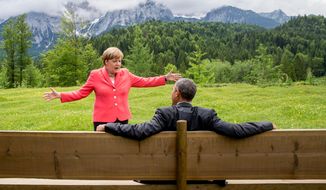 German Chancellor Angela Merkel speaks with U.S. President Barack Obama at Schloss Elmau hotel near Garmisch-Partenkirchen, Germany, Monday, June 8, 2015, during the G-7 summit. (Michael Kappeler/Pool Photo via AP)