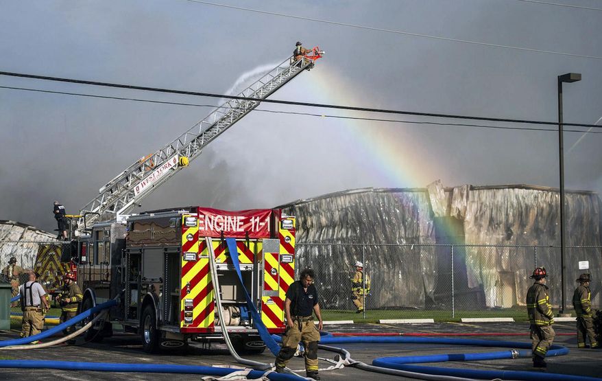 Members of the West York fire department respond to a burnt structure near High Street, Monday, June 8, 2015, in Hanover, Pa. Officials say smoke generated from the Miller Chemical and Fertilizer fire is not considered toxic, though residents within a mile of the fire were asked to shelter in place as a precaution. (Clare Becker/The Evening Sun via AP)