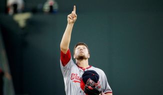 Washington Nationals starting pitcher Blake Treinen points to the sky before throwing his first pitch in the first inning of a baseball game against the Atlanta Braves, Wednesday, Sept. 17, 2014, in Atlanta. (AP Photo/David Goldman)