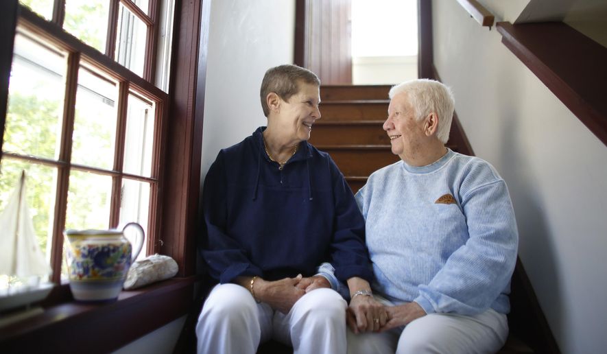 In this Thursday, June 4, 2015 photo married couple Linda Bailey-Davies, 69, left, and Gloria Bailey-Davies, 74, both of Orleans, Mass., sit together for a photo in their home, in Orleans. As the U.S. Supreme Court ponders the future of same-sex marriage, Massachusetts, the first state to legalize gay marriage, offers a decade-long real world test of what happens when gay couples can legally marry. (AP Photo/Steven Senne)