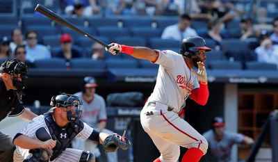 The Nationals&#39; Denard Span hits an RBI single in the 11th inning to allow Tyler Moore to score the game-winning run in a 5-4 victory against the Yankees Wednesday. (Associated Press)