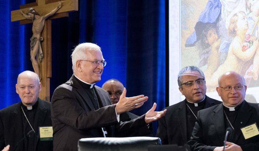 Archbishop Joseph Kurtz, right, of Louisville, and president of the U.S. Conference of Catholic Bishops, greets new members of the U.S. Conference of Catholic Bishops&#39; during the Spring General Assembly in St. Louis, Wednesday, June 10, 2015. Roman Catholic bishops are condemning racism in the U.S. in light of national tensions over police treatment of African-Americans. (AP Photo/Sid Hastings)