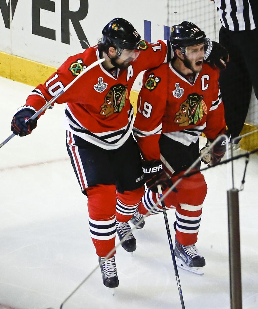 Chicago Blackhawks&#x27; Jonathan Toews, right, is congratulated by Patrick Sharp after scoring during the second period in Game 4 of the NHL hockey Stanley Cup Final against the Tampa Bay Lightning Wednesday, June 10, 2015, in Chicago. (AP Photo/Charles Rex Arbogast)